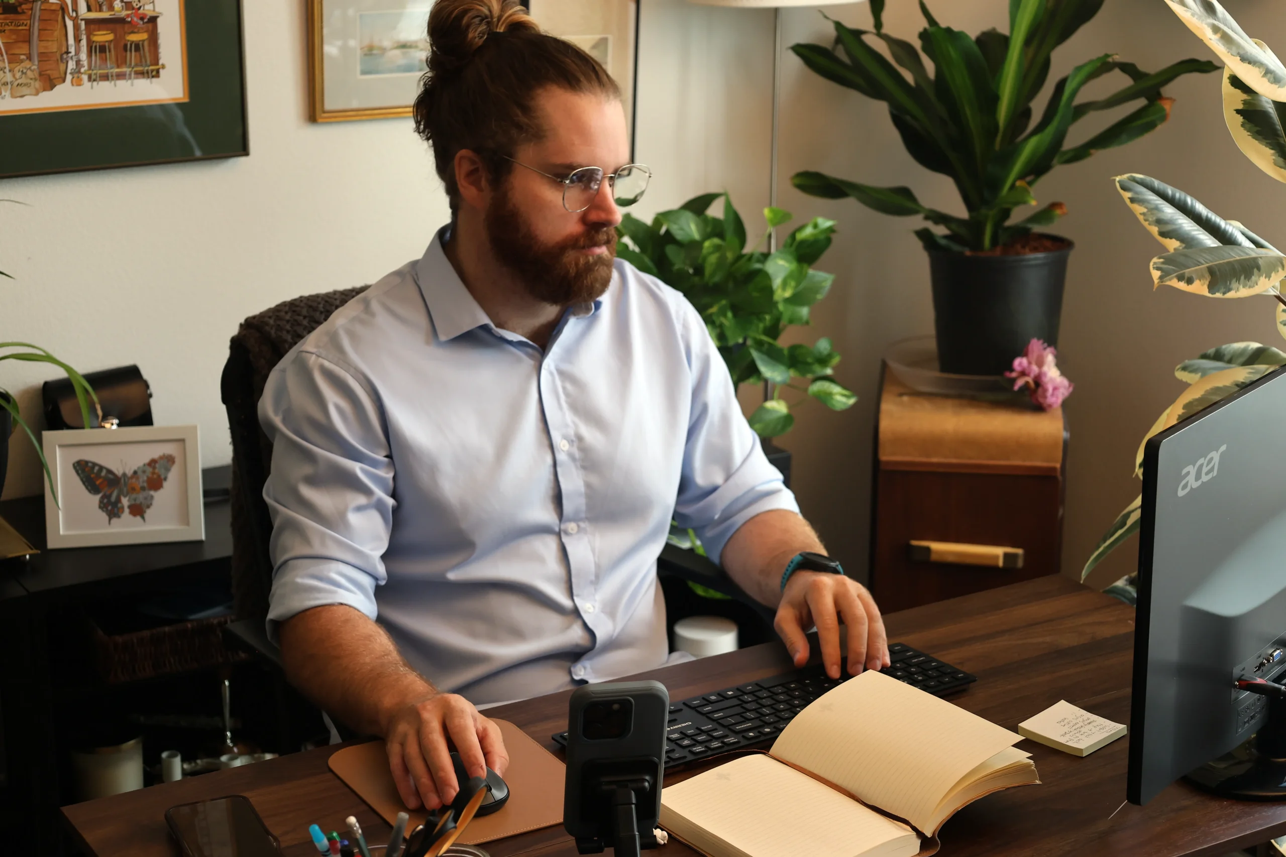 Nick working at his desk reviewing operational systems and business workflows for FnButton